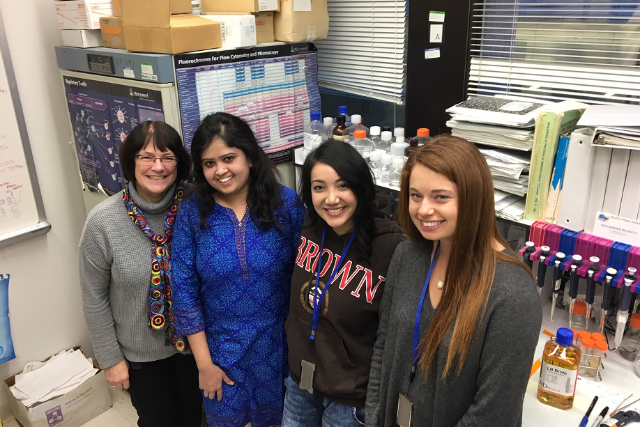 Dr. Bev Mock and three trainees in the lab
