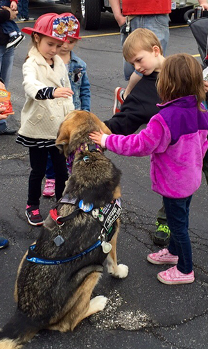 Children petting a dog