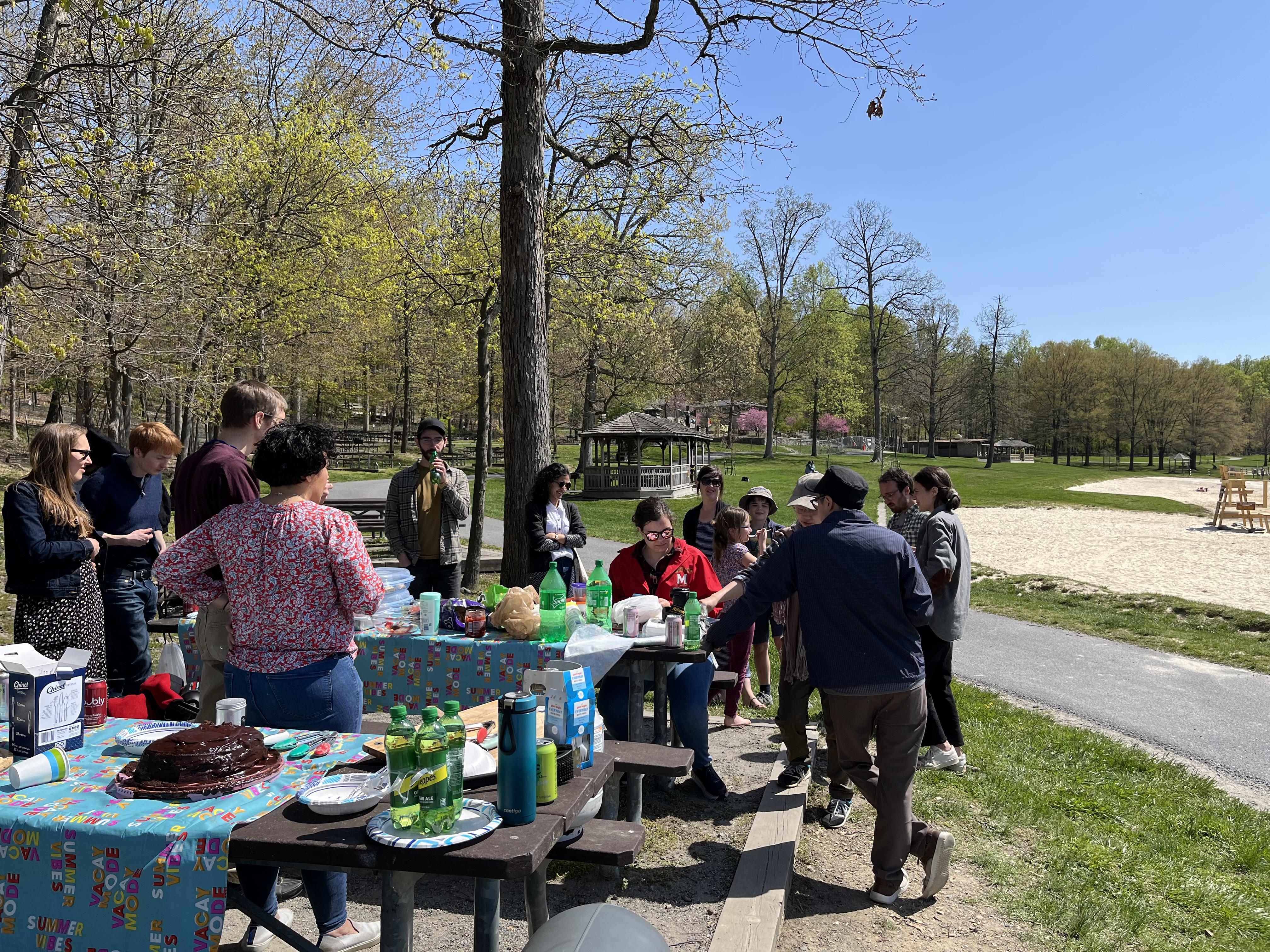 People standing by a table in the park