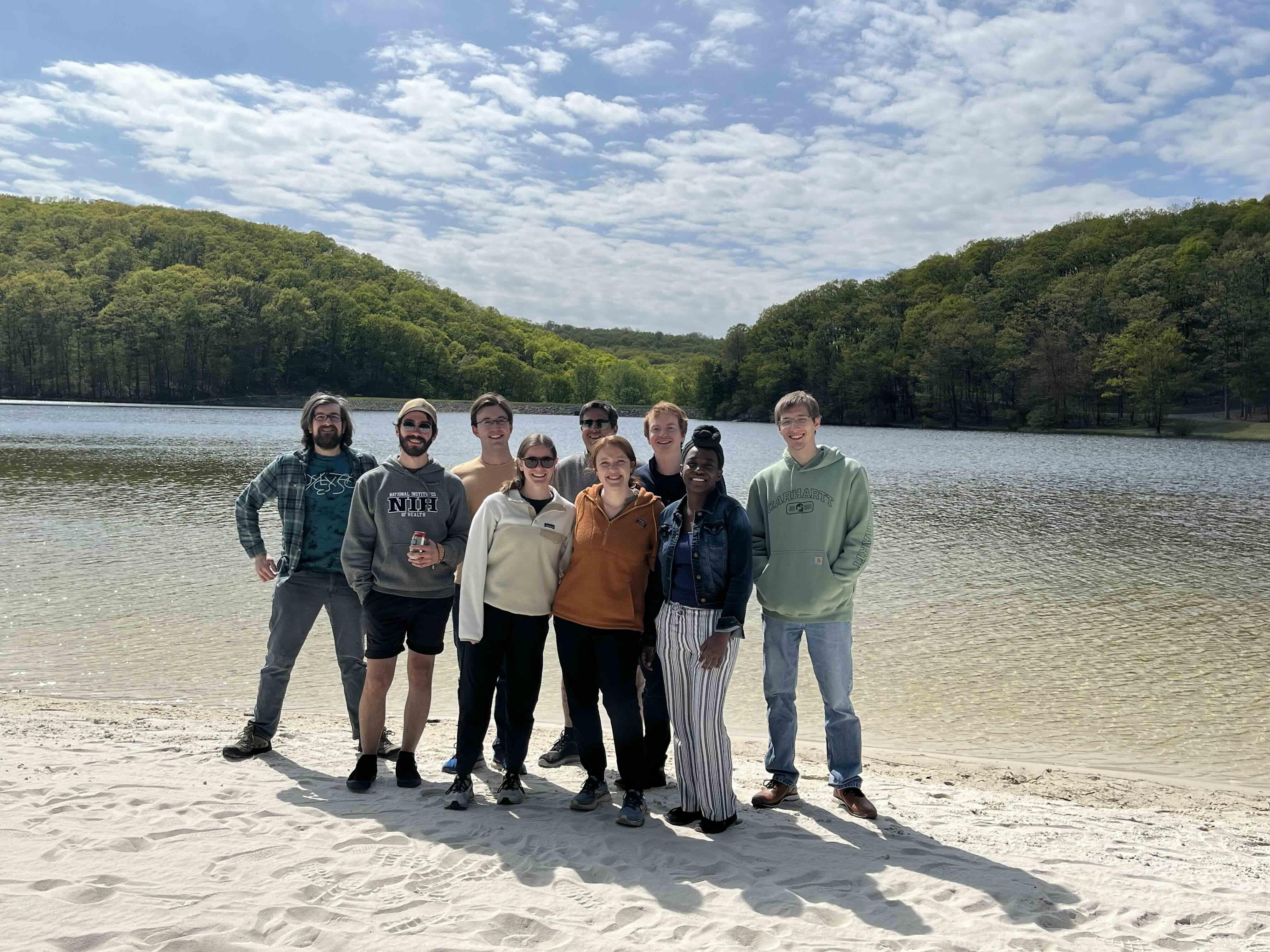 Group of people standing by a lake