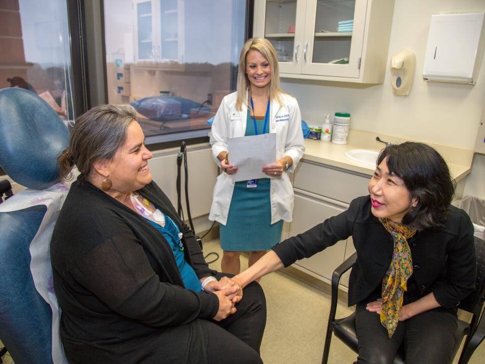 A patient speaks with staff in the women's malignancies clinic