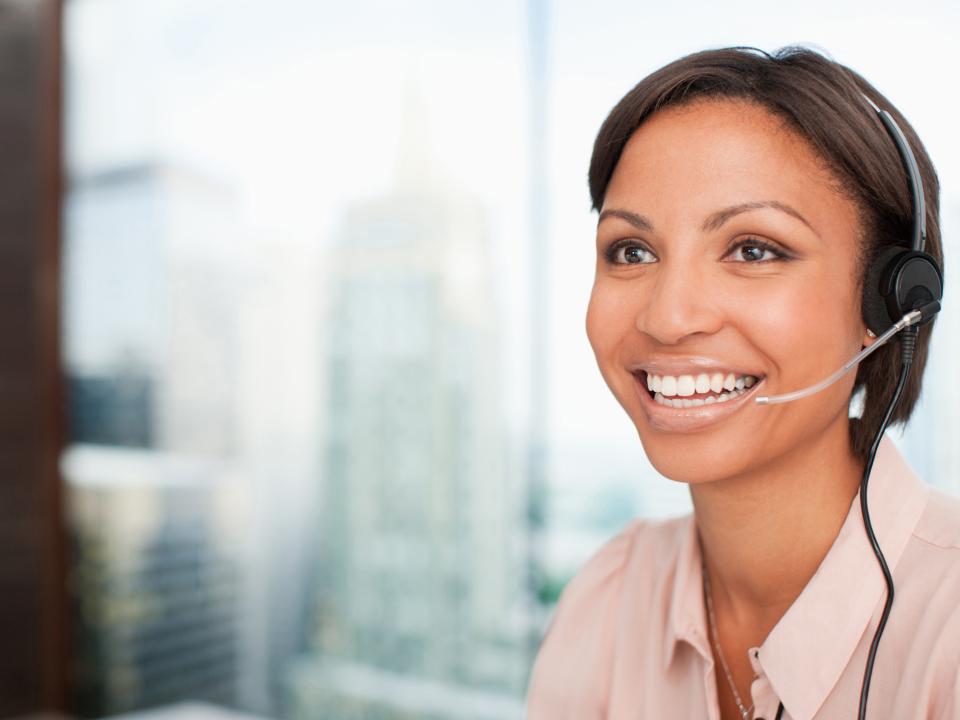 Clinical trials specialist wearing a headset and smiling while talking