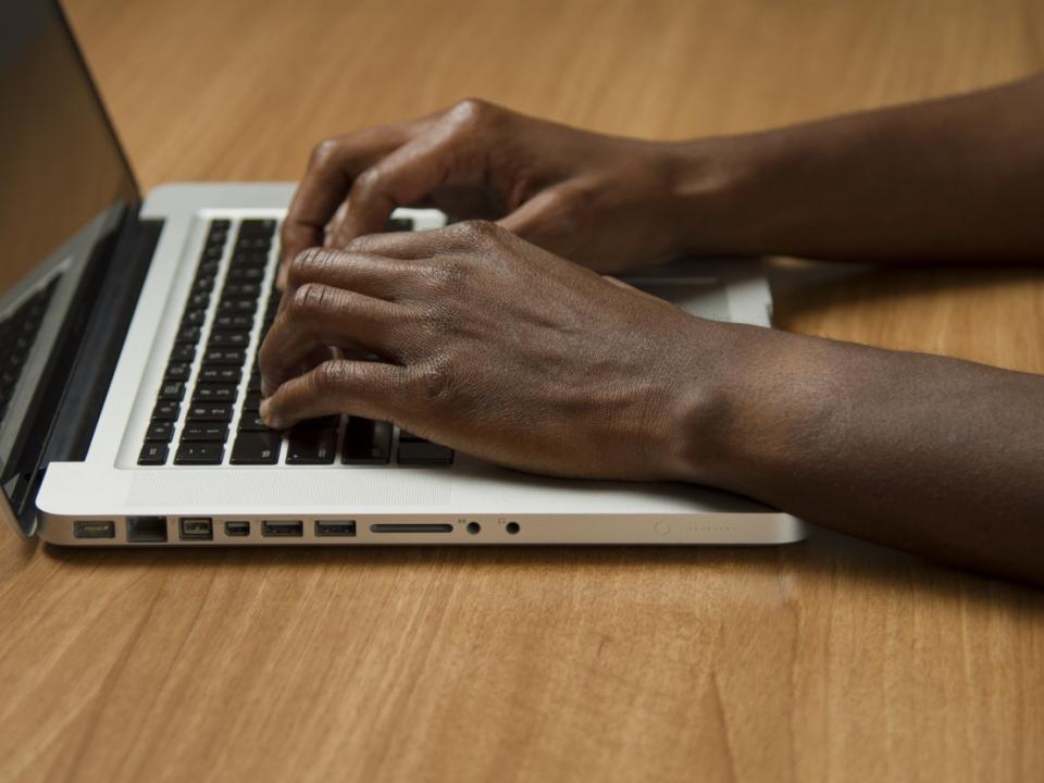 person typing on a laptop