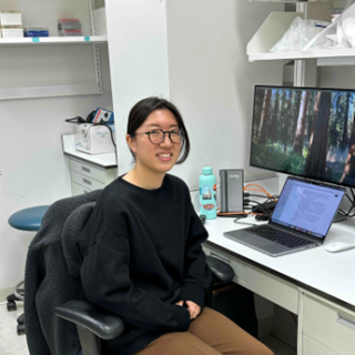 Photo of Dr. Tabe at her desk.