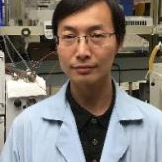 Dong in light blue lab coat and glasses