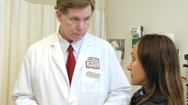 Marston Linehan, M.D., discusses treatment with a patient.