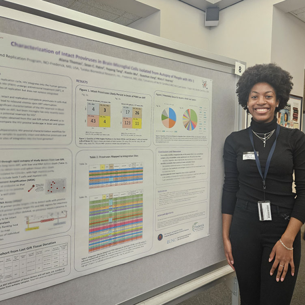 Photo of Alana Thomas presenting a poster