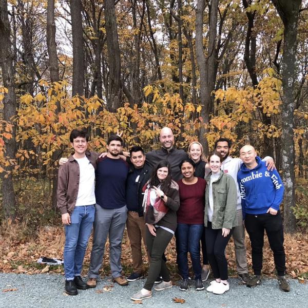 Meier lab group standing in front of trees with fall foliage.
