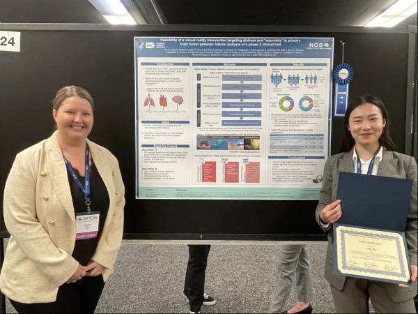 Dr. Amanda King (left) and Emily Wu (right) in front of poster
