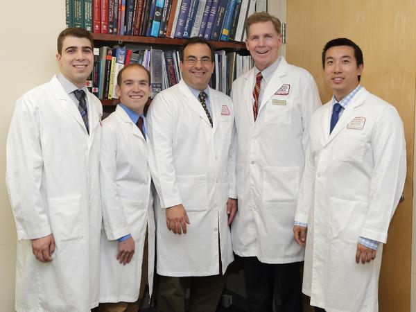 Group of doctors in front of a book shelf.