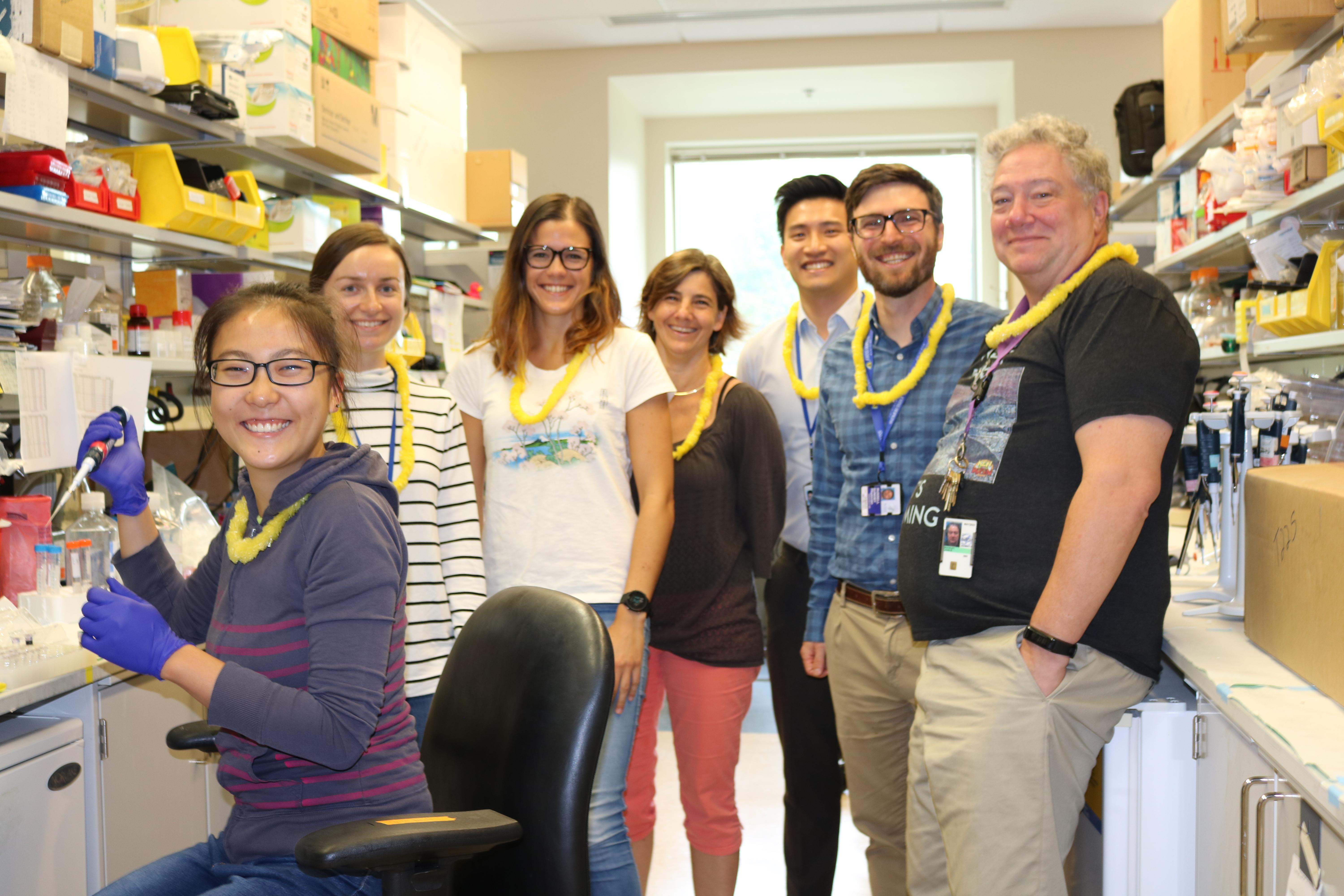 Researchers with yellow leis