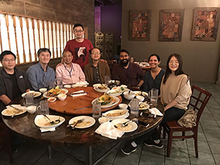 Group of lab members seated around a restaurant table