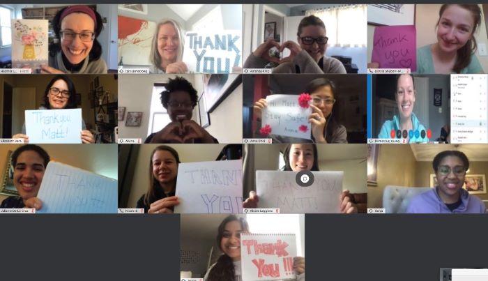 various staff members holding signs saying thank you