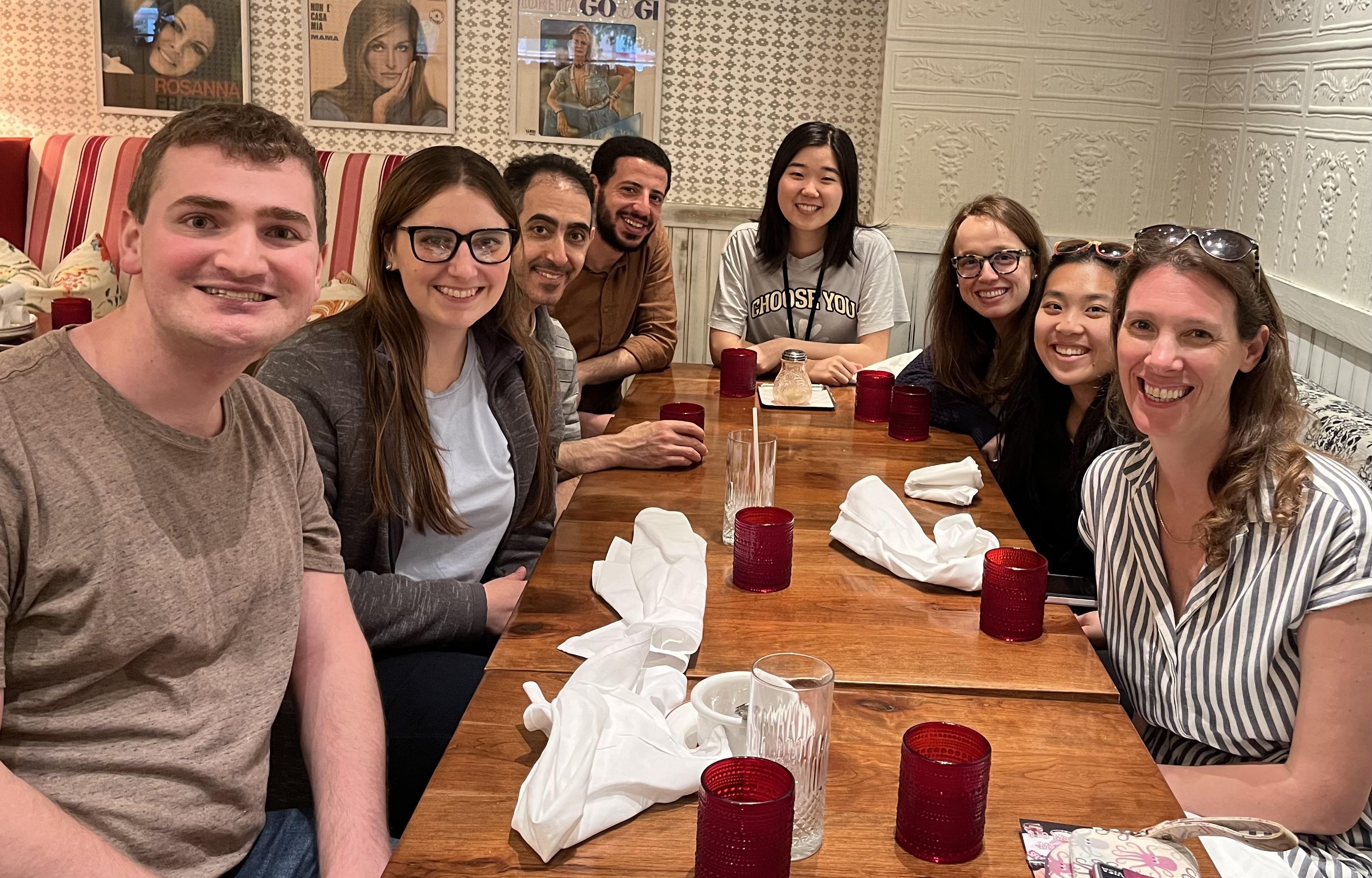 A group sits around a dining table