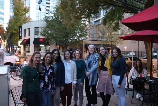 The team gathers outside of a restaurant to enjoy time outside of work.