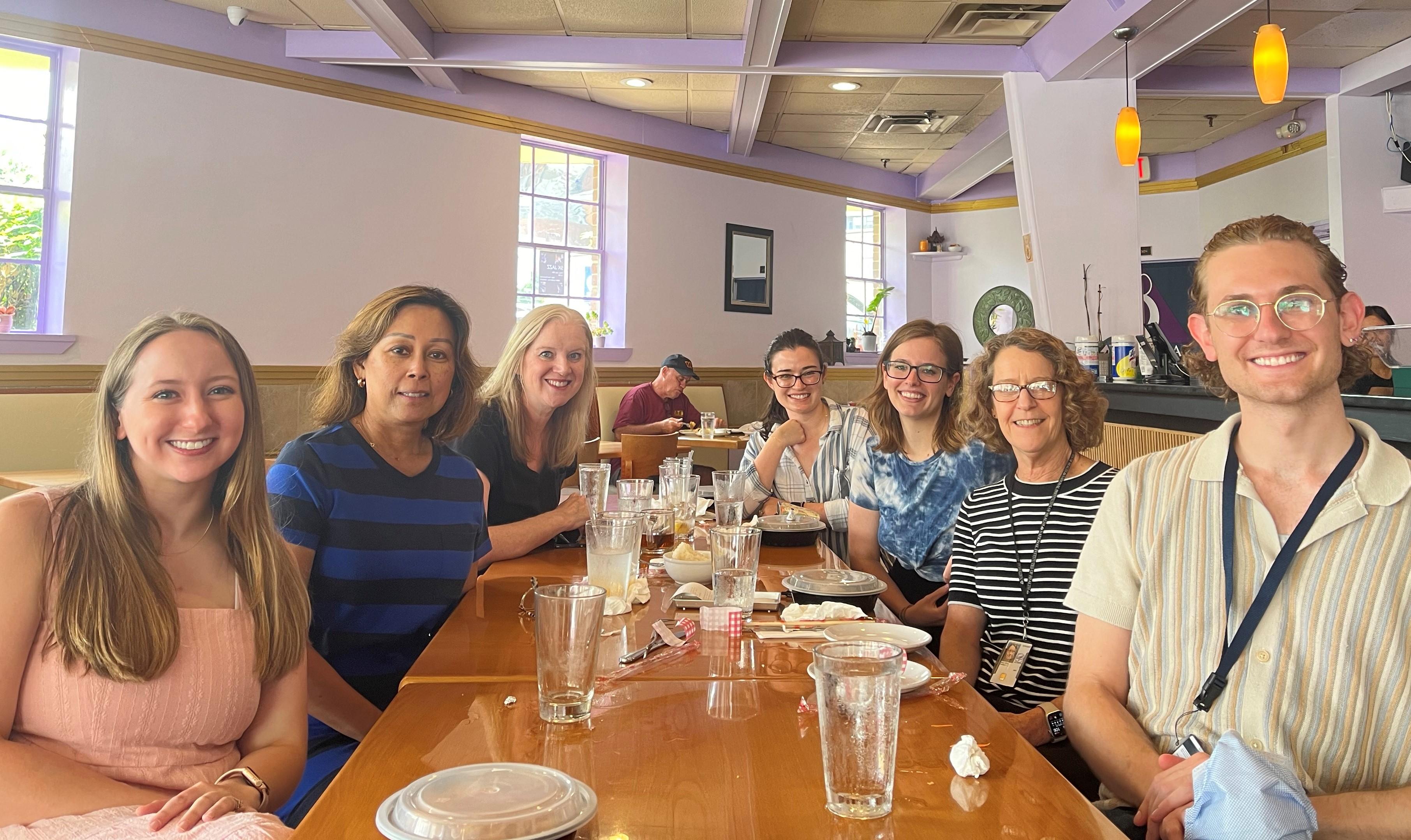 the group sits around a table at a restaurant