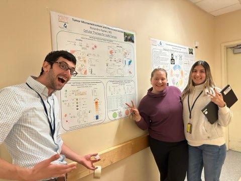 Lab members pose at a poster presentation