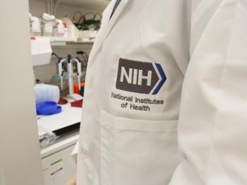 Person wearing an NIH lab coat with logo
