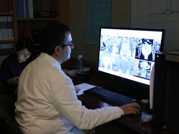 Dr. Turkbey looking at image scans on a computer monitor.